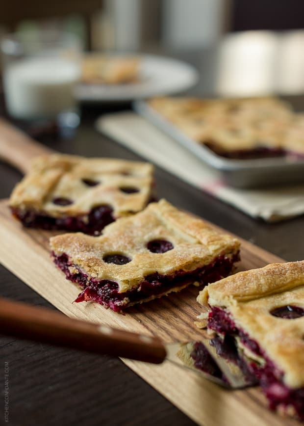 Slices of Cranberry Sauce Slab Pie on a wooden serving board.