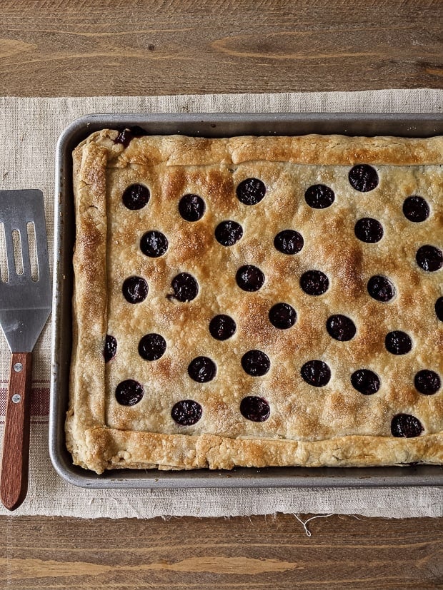 A Cranberry Sauce Slab Pie on a wooden surface.