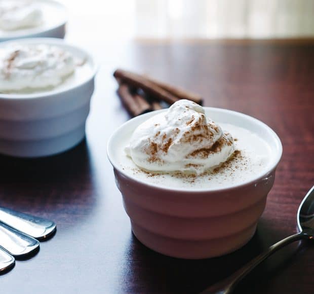 A small bowl of eggnog mousse topped with whipped cream.