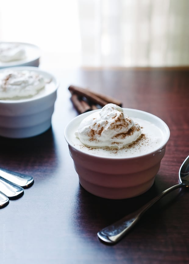 A small bowl of eggnog mousse topped with whipped cream.