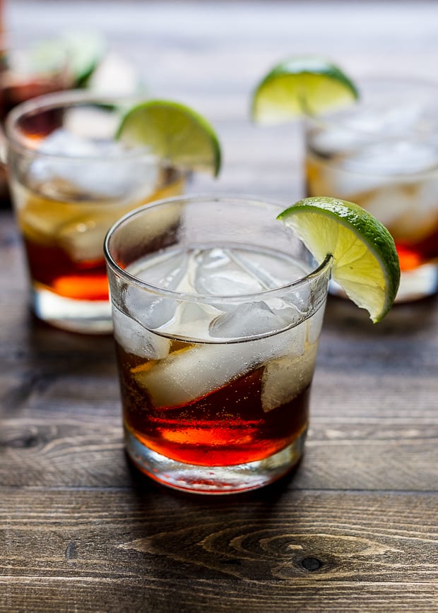 A Pumpkin Spice Dark and Stormy Cocktail on a wooden surface.