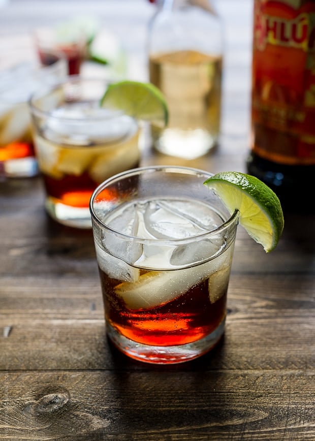 Pumpkin Spice Dark and Stormy Cocktail in a glass with a slice of lime on the rim.