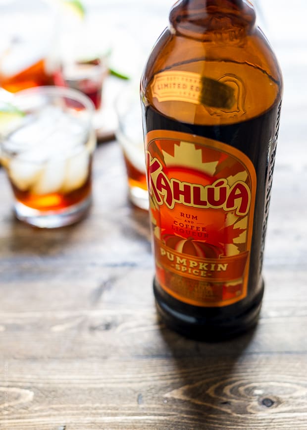 A bottle of Kahlua Pumpkin Spice on a wooden surface.