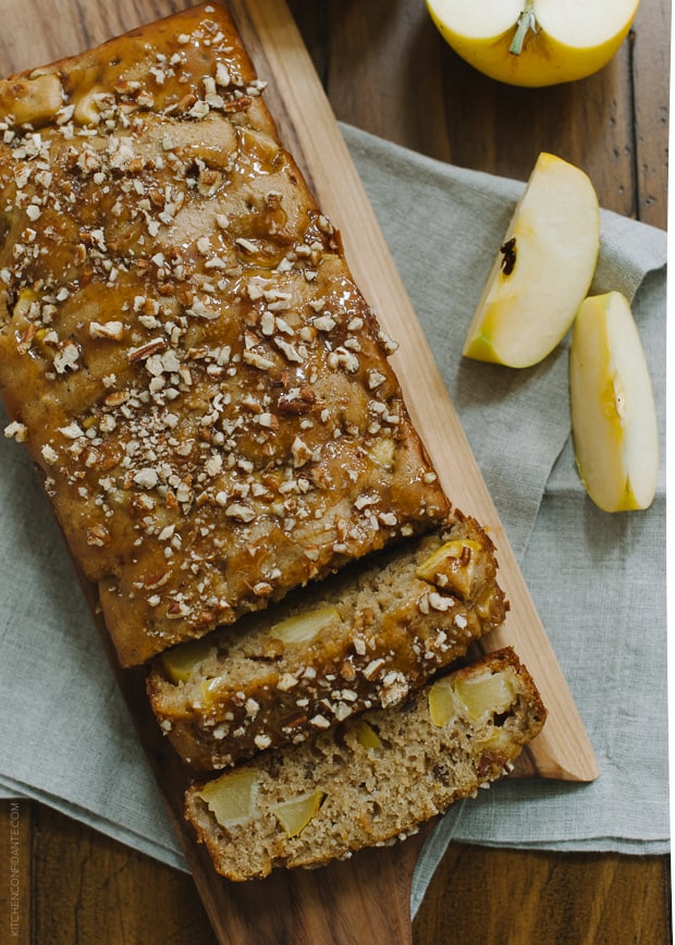 Apple Pecan Loaf Cake drizzled with caramel sauce and topped with chopped pecans.