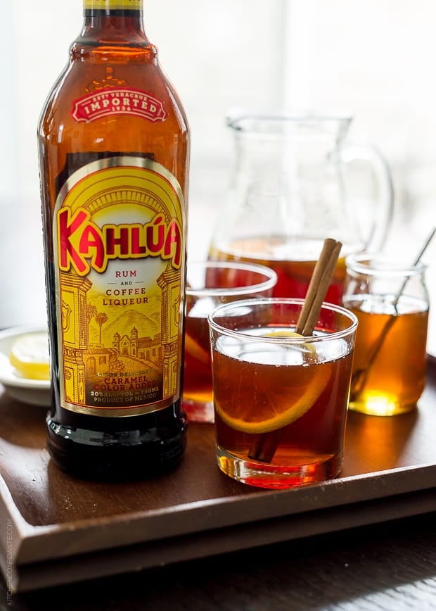 Kahlúa bottle alongside a Chai Hot Toddy in a glass.