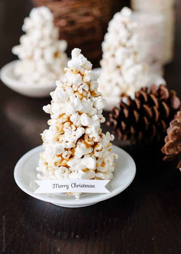 A Popcorn Christmas Tree Place Card with a tag that says, "Merry Christmas" on it.