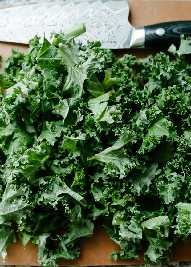 Kale on a cutting board for Sweet Potato and Kale Coconut Curry Soup.