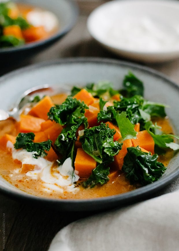 Sweet Potato and Kale Coconut Curry Soup in a grey bowl.