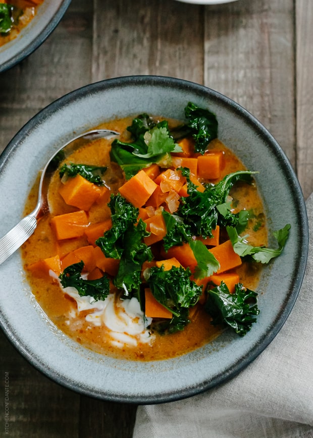 Sweet Potato and Kale Coconut Curry Soup in a grey bowl