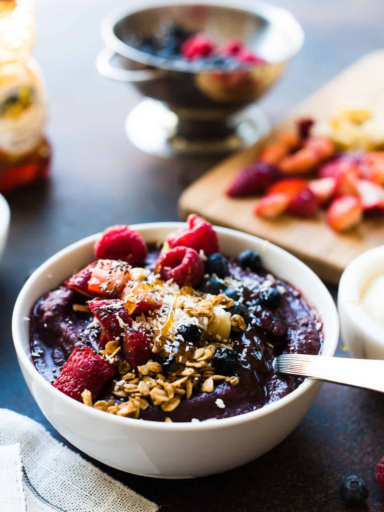 Acai Berry Bowl topped with strawberries, blueberries, raspberries, bananas, coconut, granola, chia seeds and honey.