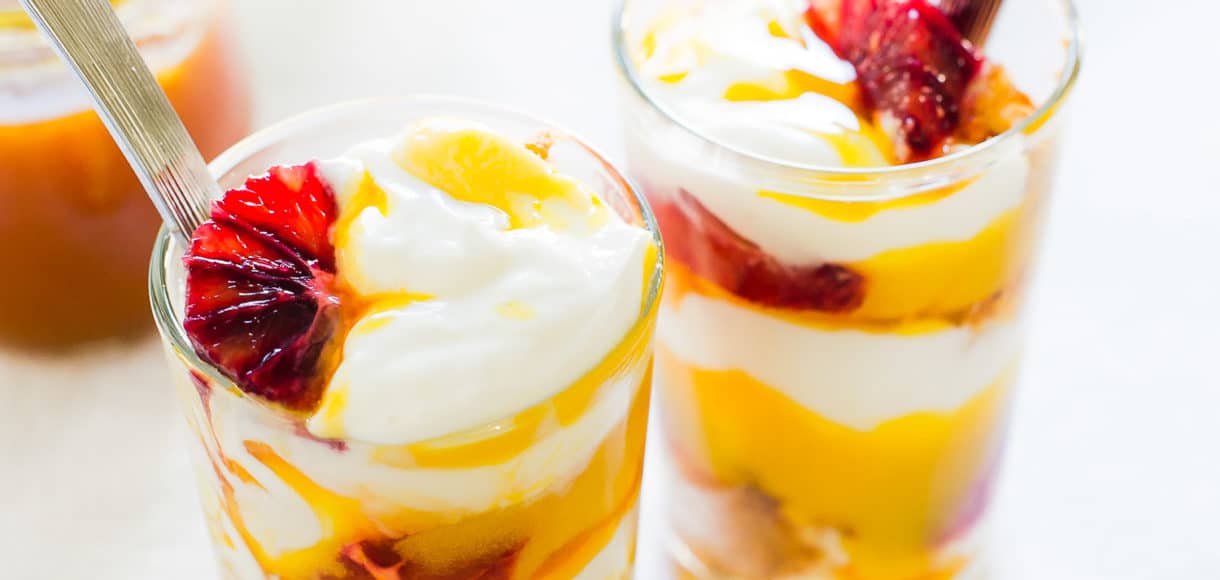 Passion Fruit Blood Orange Trifle in glasses with slices of blood orange.