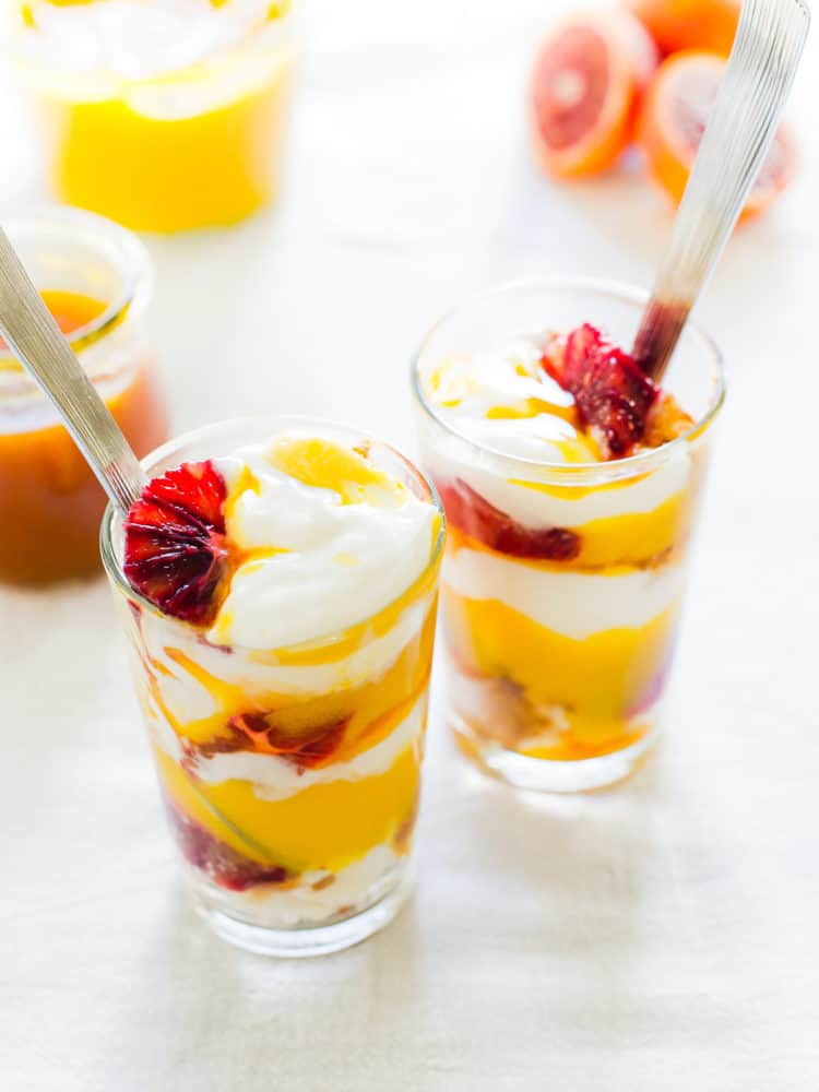 Passion Fruit Blood Orange Trifle in glasses with slices of blood orange.