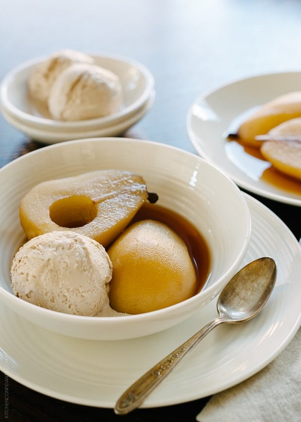 Tea Poached Pears with Earl Grey Ice Cream served in a white bowl.