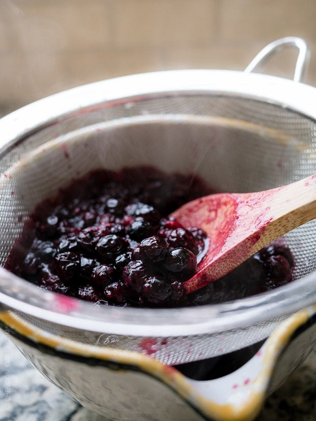 Straining Blueberries for Blueberry Lemon Curd.