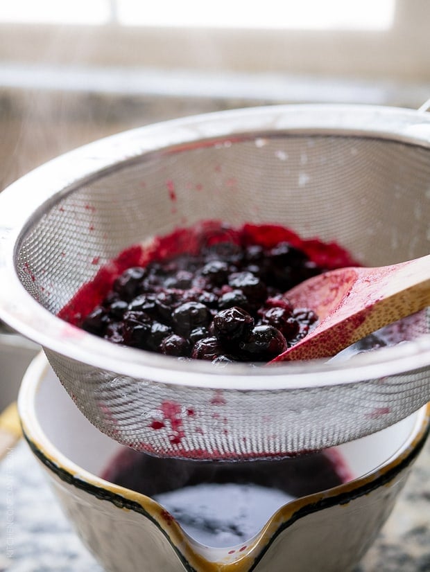 Straining blueberries for Blueberry Lemon Curd.