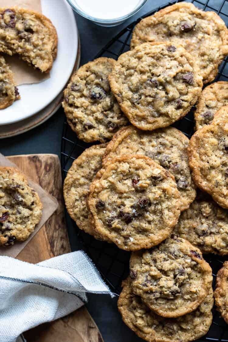 A stack of Chocolate Chip Cranberry Oat Cookies alongside a tall glass of milk.