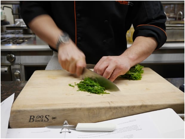 Chopping herbs at the US Highbush Blueberries CIA Bootcamp