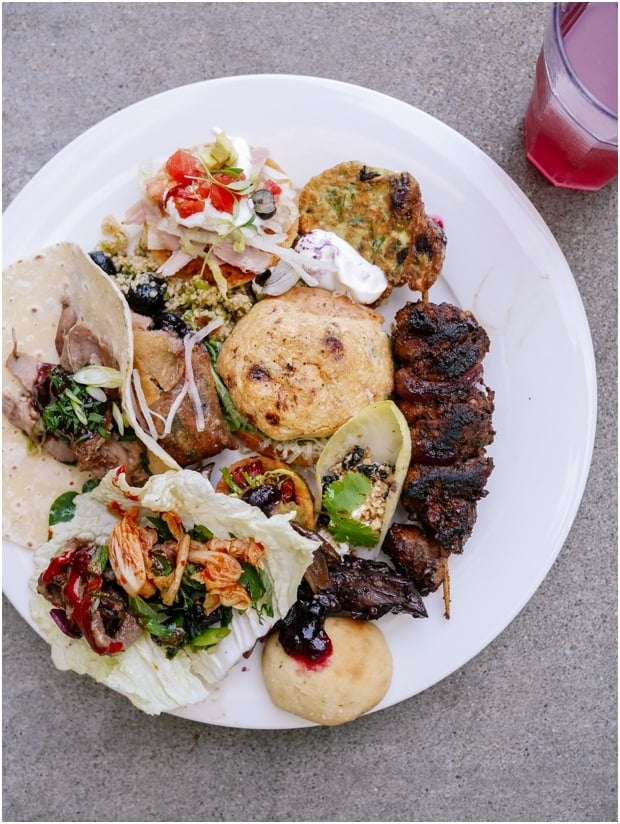 A variety of dishes on a white plate at the Blueberry Culinary Bootcamp at Culinary Institute of America.