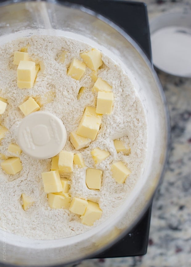 Cubed butter on top of the dry ingredients in a food processor to make Boursin Garlic & Herb Buttermilk Biscuits.