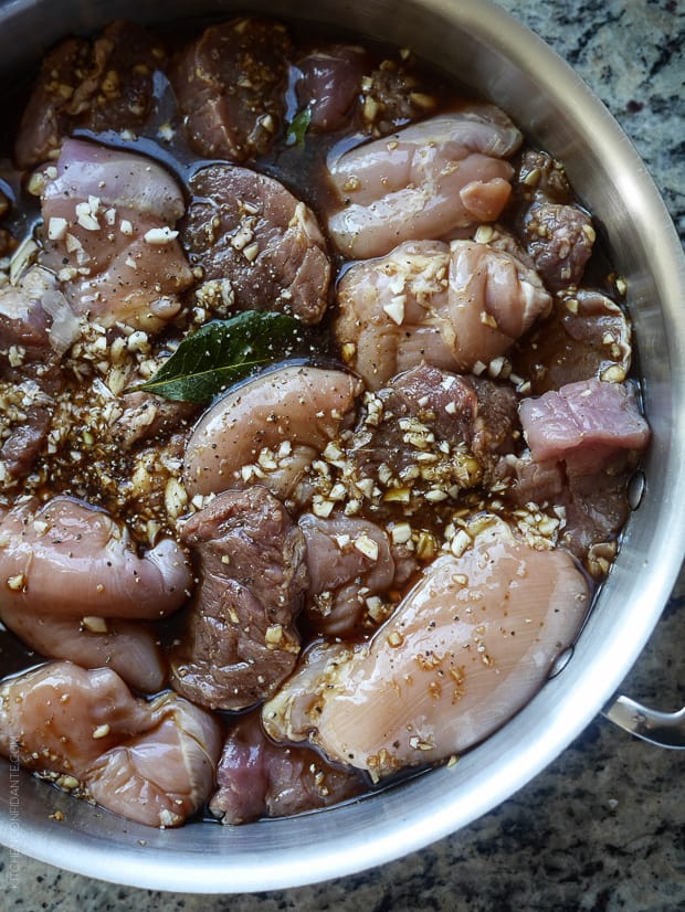 Chicken and pork marinating in soy sauce, vinegar and garlic.