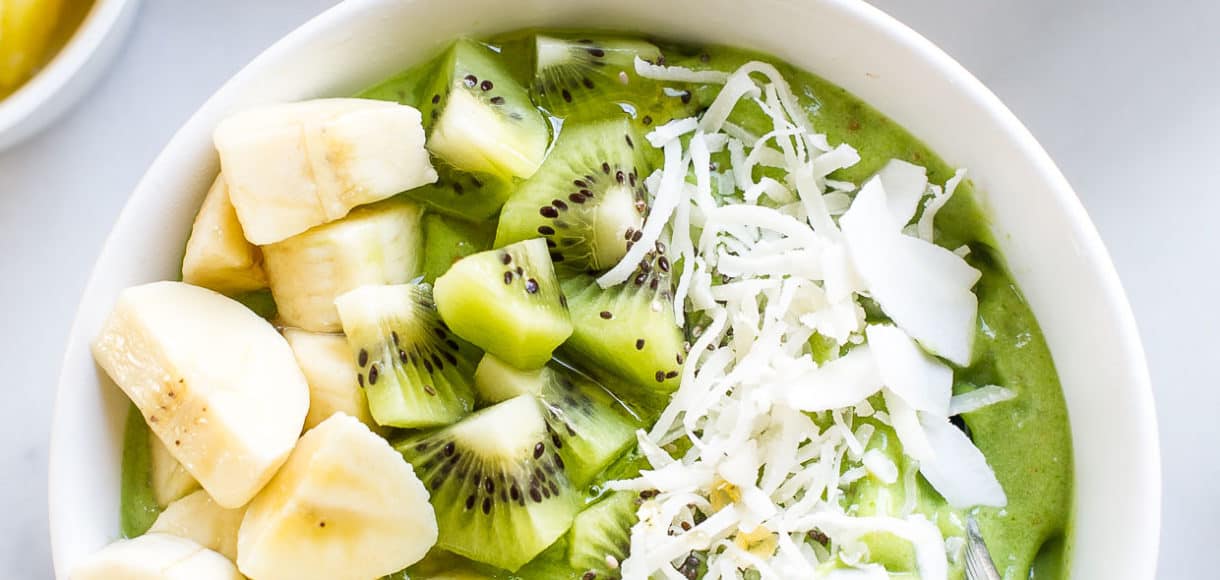 Green Smoothie Bowl topped with kiwi and banana in a white bowl