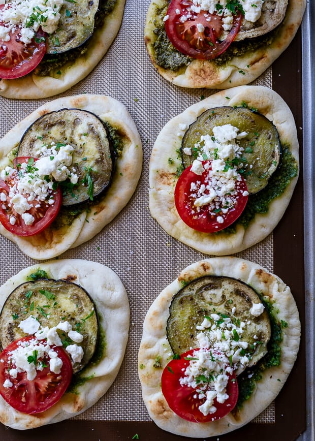 Roasted Eggplant, Tomato and Pesto Mini Naan on a baking sheet.