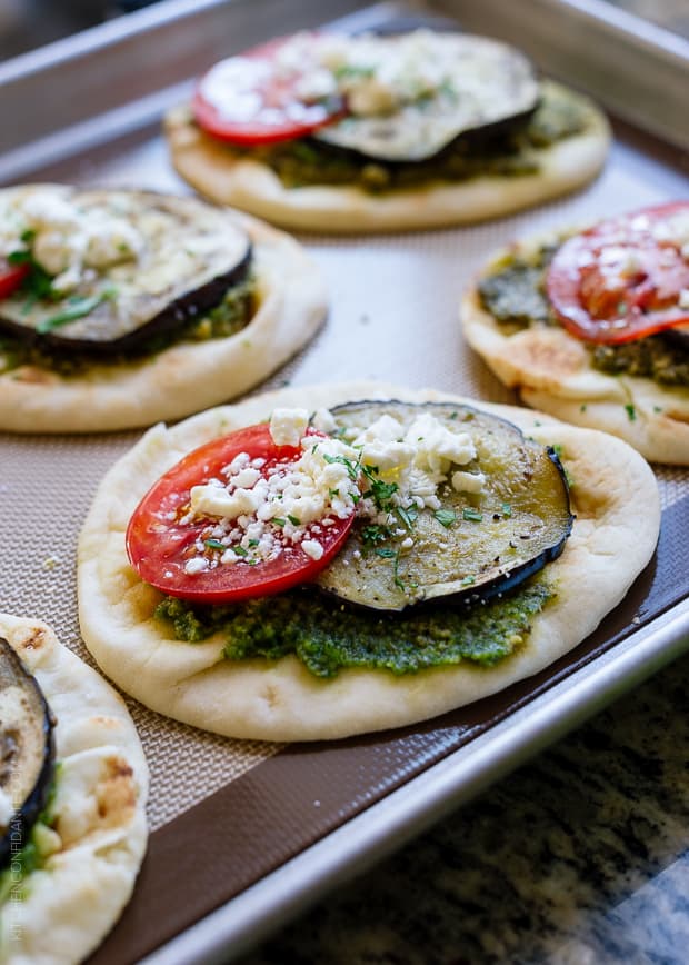 Roasted Eggplant, Tomato and Pesto Mini Naan on a baking sheet.