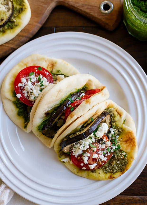 Roasted Eggplant, Tomato & Pesto Mini Naan on a white plate.