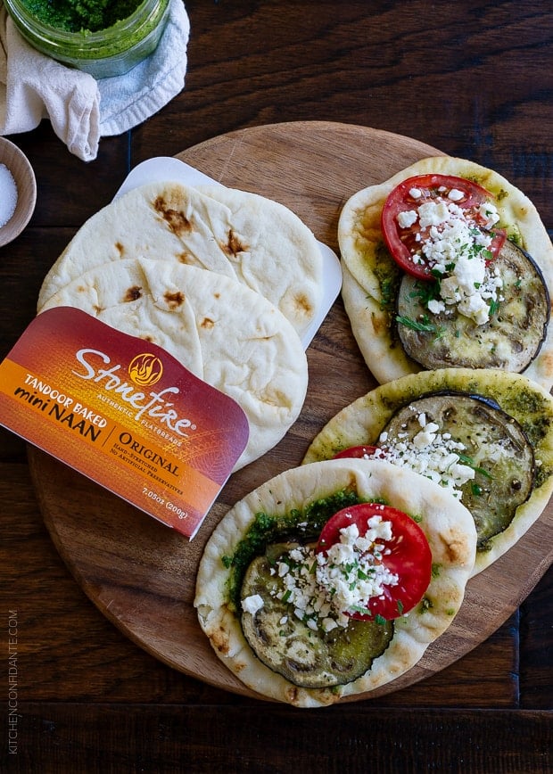 Roasted Eggplant, Tomato and Pesto Mini Naan on a wooden surface. 