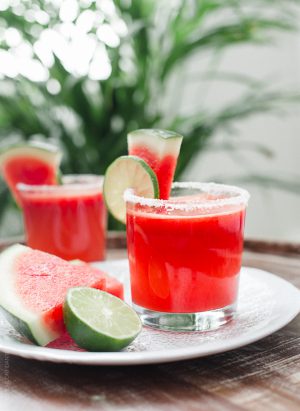 Watermelon Lime Margaritas garnished with slices of lime and watermelon.