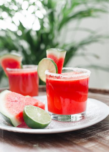 Watermelon Lime Margaritas garnished with slices of lime and watermelon.