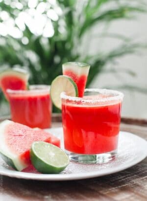Watermelon Lime Margaritas garnished with slices of lime and watermelon.