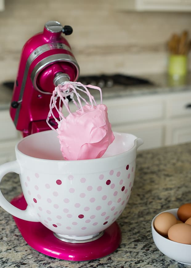 Pink meringue in a KitchenAid stand mixed ready to prepare a Raspberry Meringue Roll.