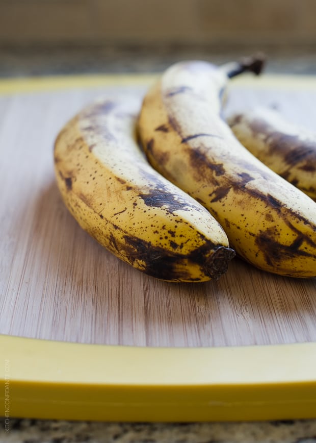 Ripe bananas on a wooden surface.