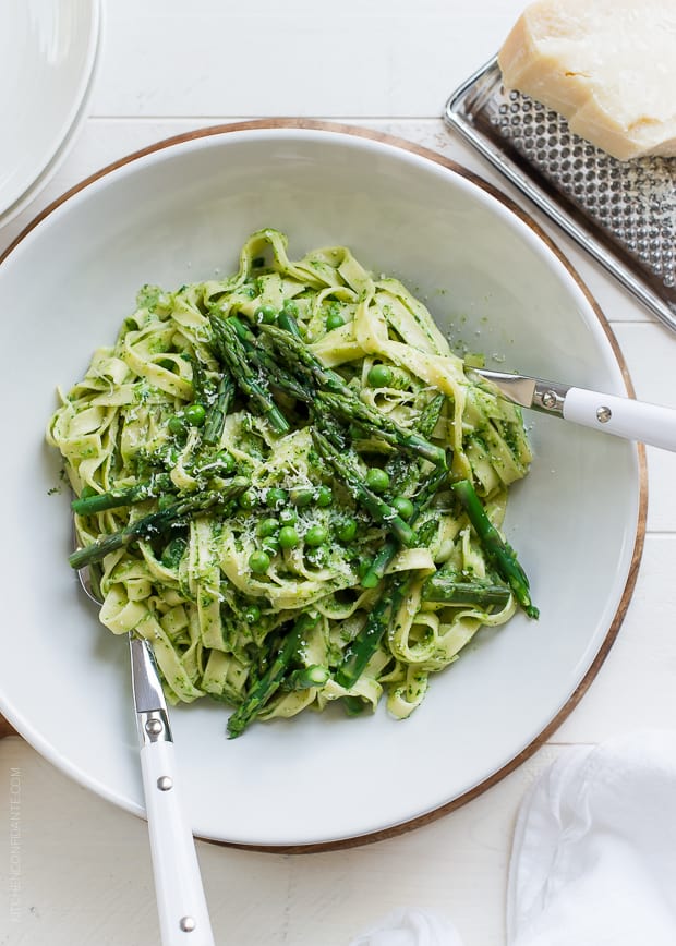 Fettuccine with Creamy Spinach Sauce, Asparagus and Peas in a white bowl.