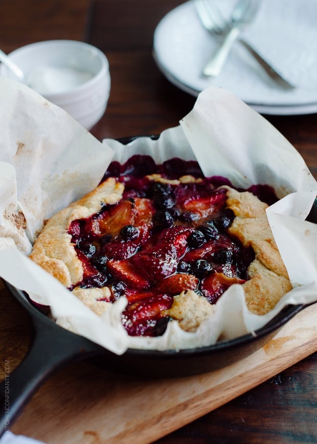 Mixed Berry Cornmeal Galette in a cast iron skillet.