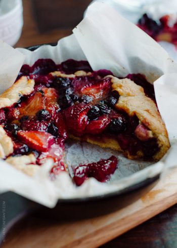 Mixed Berry Cornmeal Galette in a cast iron skillet.
