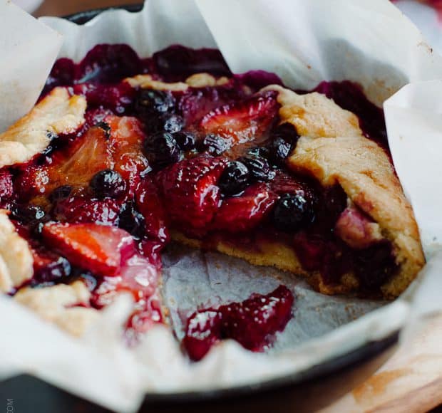 Mixed Berry Cornmeal Galette in a cast iron skillet.