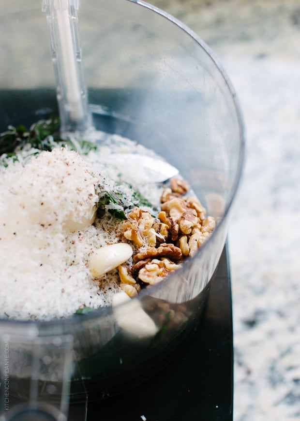 Pesto ingredients in a food processor.