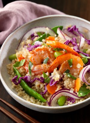 Thai Shrimp and Coconut Quinoa Bowl on a wooden surface.
