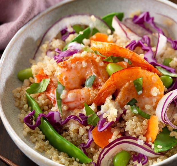 Thai Shrimp and Coconut Quinoa Bowl on a wooden surface.