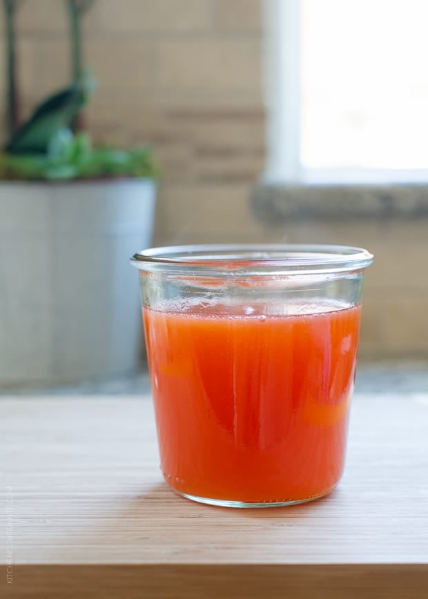 Bright orange-red dipping sauce for Lumpiang Shanghai - Filipino Spring Rolls (Lumpia) in a glass jar