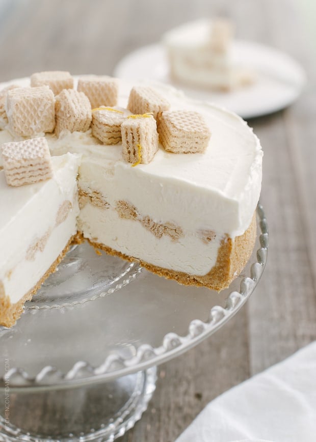 No-Churn Cheesecake Ice Cream Cake on a cake stand with slices removed.