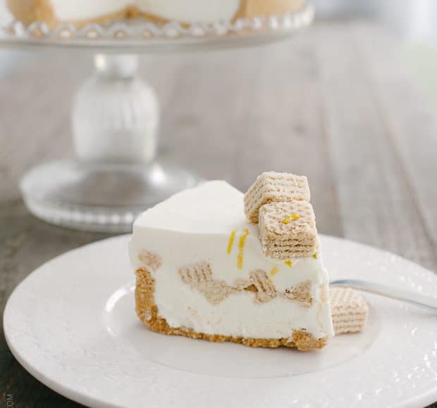 A slice of No-Churn Cheesecake Ice Cream Cake on a white plate.