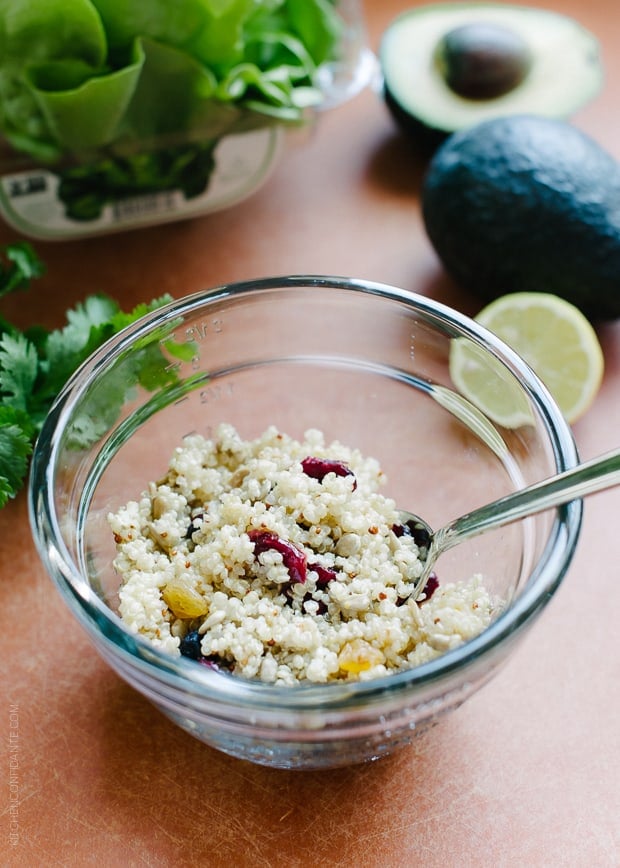 A small bowl filled with cooked quinoa and dried cranberries.