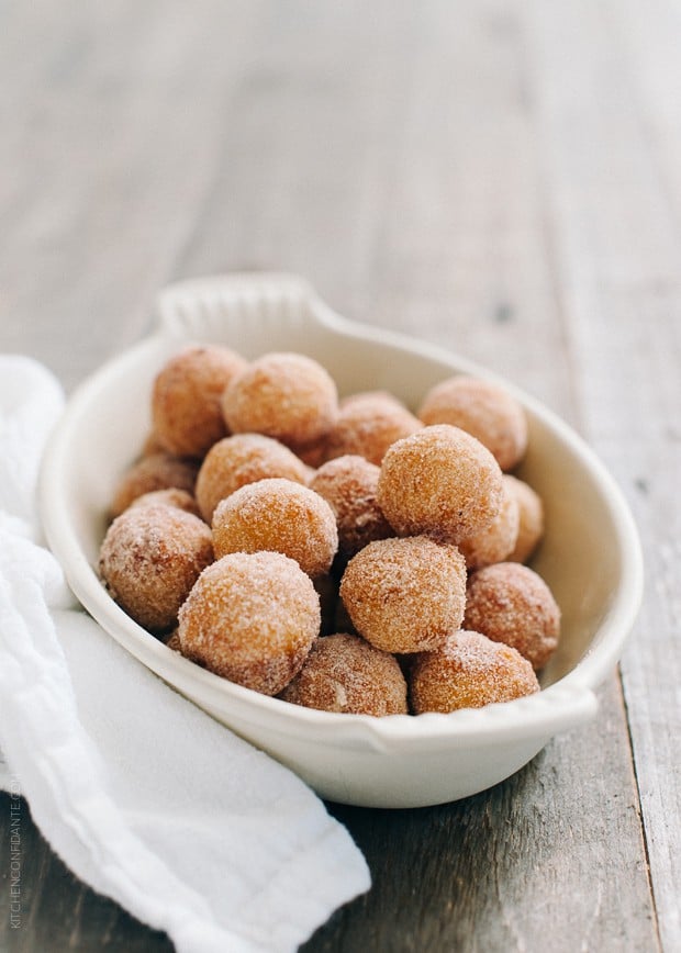 A small white bowl of fresh churro doughnut holes.