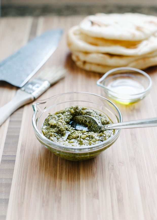 A small glass bowl filled with pesto.