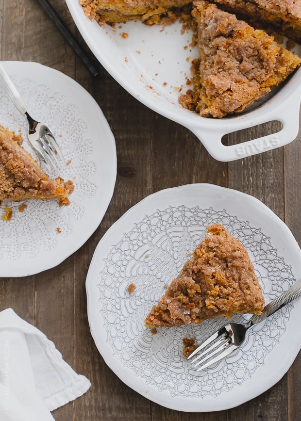 Slices of Buttered Rum and Candied Sweet Potato Crumb Cake on plates with forks.