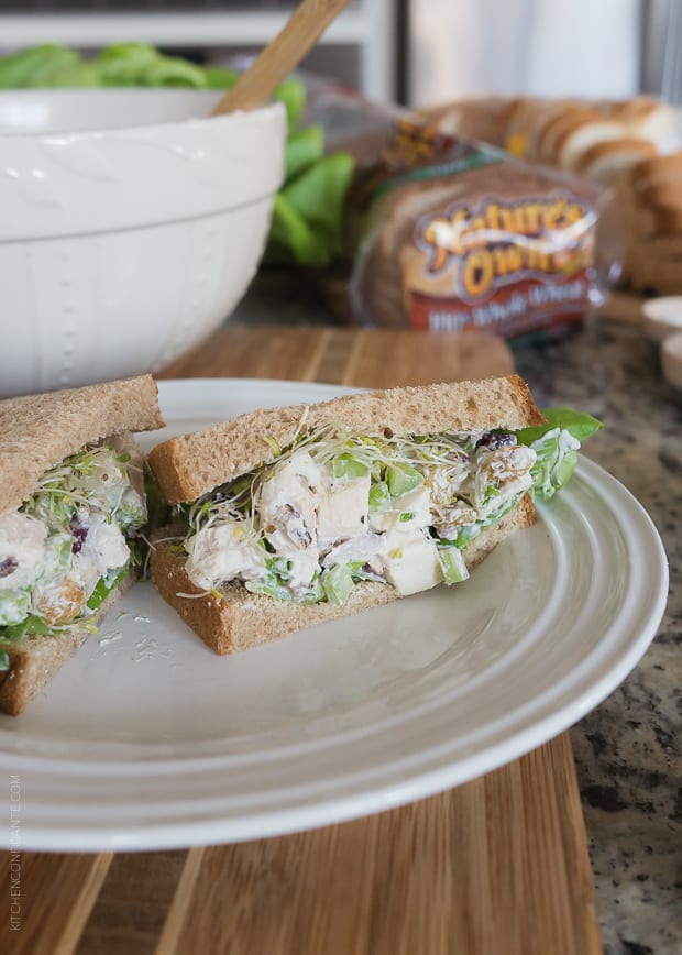 Green Apple Chicken Salad (Mayo Free) packed into a sandwich and served on a white plate.