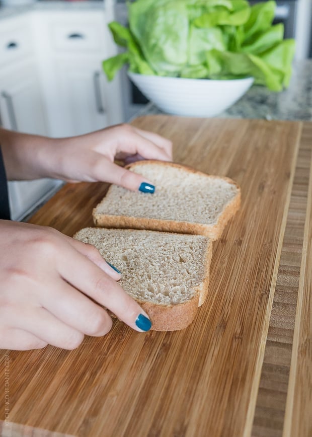 Preparing slices of bread for a chicken salad sandwiches.